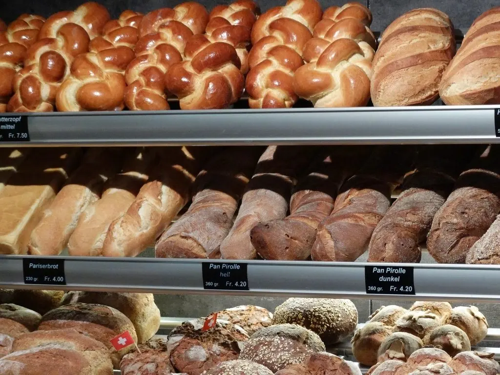 Bakery display case filled with loaves and braided bread